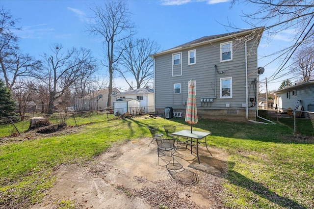 rear view of house with a patio, a fenced backyard, and a yard