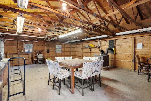 4824 Little Cedar Creek Dr, Attica, MI 48412 - dining space featuring concrete flooring and wood walls