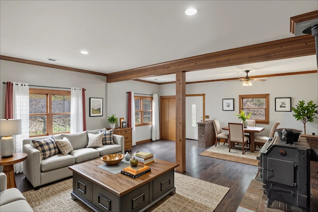 4824 Little Cedar Creek Dr, Attica, MI 48412 - living room featuring a wood stove, healthy amount of natural light, recessed lighting, dark wood-type flooring, and crown molding