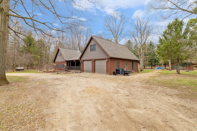 4824 Little Cedar Creek Dr, Attica, MI 48412 - view of side of home featuring a garage, driveway, and roof with shingles