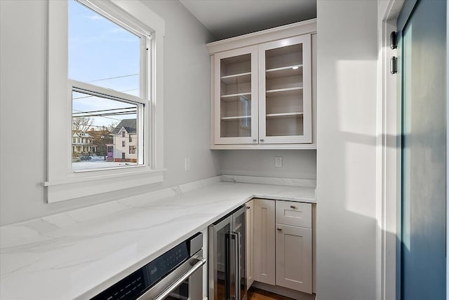 bar featuring stainless steel refrigerator and wine cooler