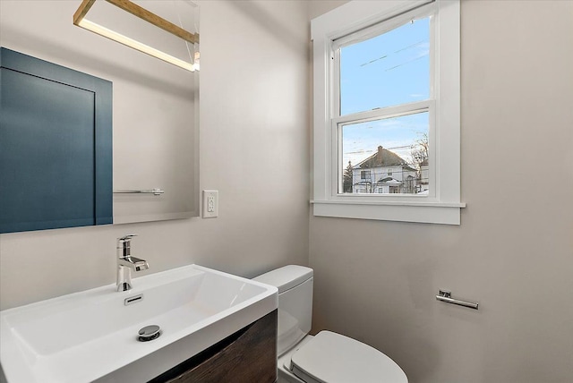 half bathroom featuring toilet and vanity