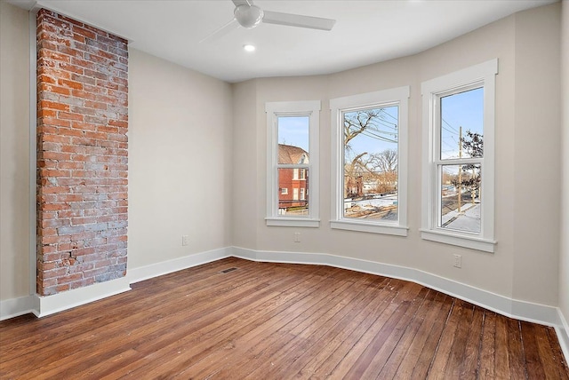 empty room featuring recessed lighting, baseboards, a ceiling fan, and dark wood finished floors
