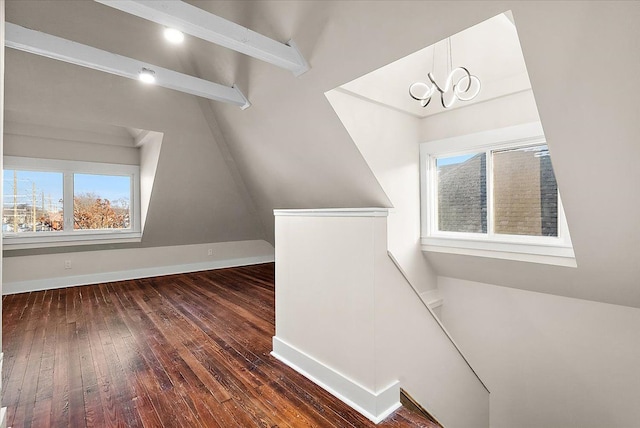 bonus room featuring baseboards, a chandelier, a wealth of natural light, and hardwood / wood-style flooring