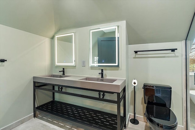 full bath with baseboards, a sink, and lofted ceiling