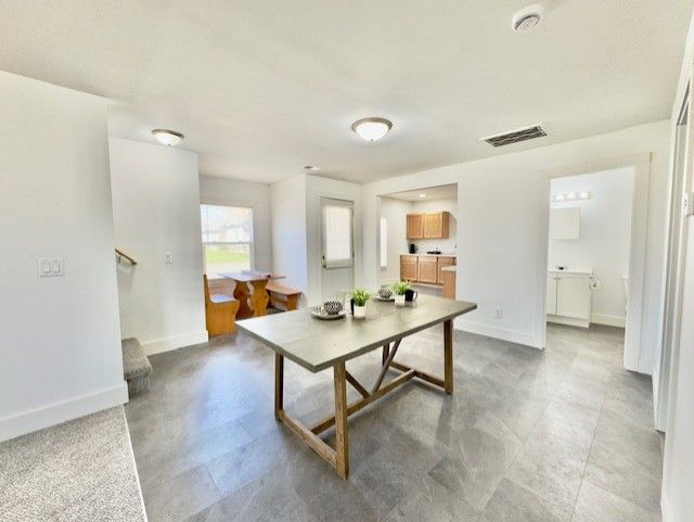 dining area with baseboards and visible vents
