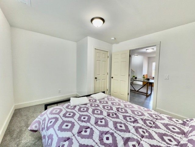carpeted bedroom featuring baseboards