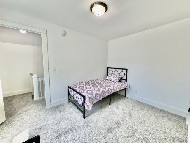 bedroom with carpet floors and baseboards