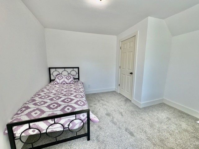 carpeted bedroom with baseboards