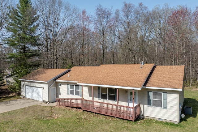 ranch-style home featuring covered porch, an attached garage, cooling unit, and roof with shingles
