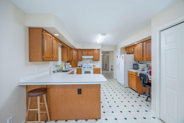 kitchen featuring a peninsula, white appliances, light floors, light countertops, and a sink