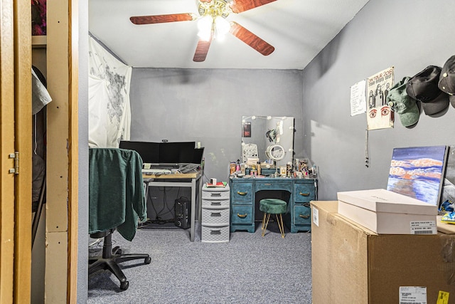 carpeted office space with ceiling fan