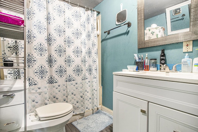 full bathroom with vanity, curtained shower, wood finished floors, toilet, and baseboards