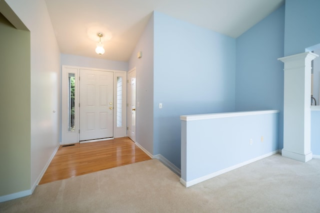 carpeted entrance foyer with baseboards