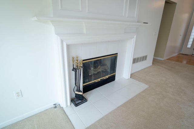 interior details with a fireplace, baseboards, carpet, and visible vents