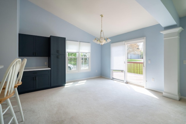 unfurnished dining area featuring light colored carpet, a wealth of natural light, and an inviting chandelier