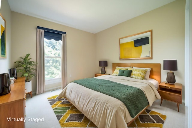 carpeted bedroom featuring visible vents
