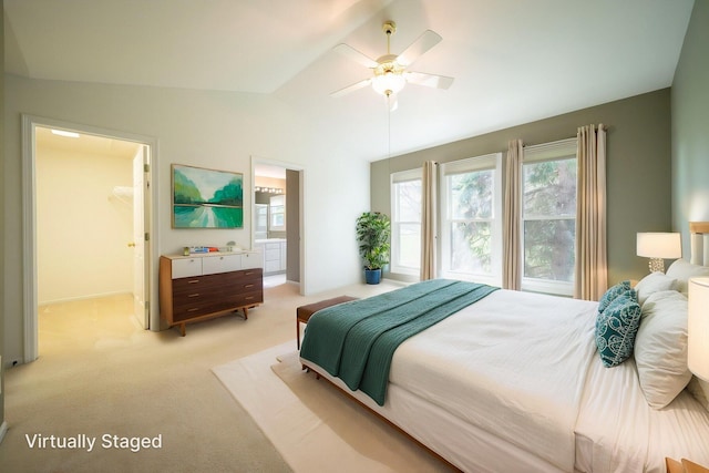 bedroom featuring a walk in closet, ceiling fan, vaulted ceiling, baseboards, and light carpet