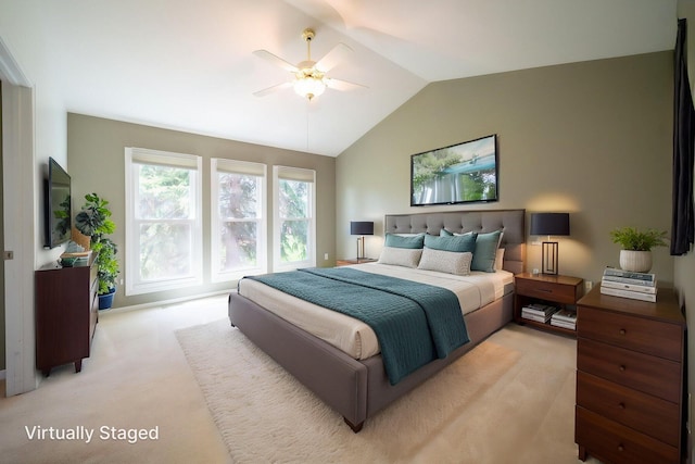 bedroom with ceiling fan, light colored carpet, and lofted ceiling