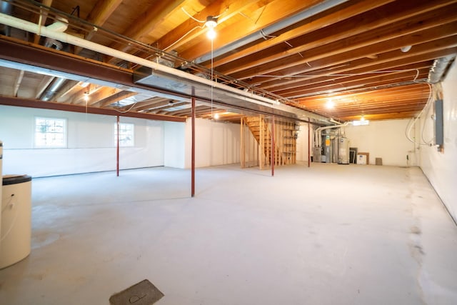 basement with electric panel and gas water heater