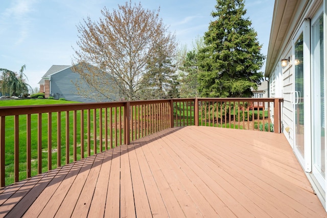 wooden terrace featuring a lawn