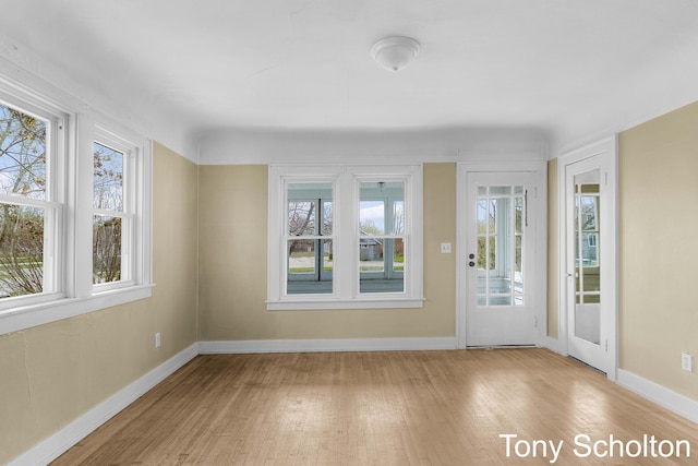 interior space with baseboards and wood finished floors
