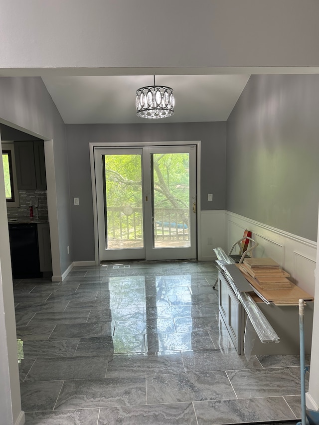 entryway with marble finish floor and a wainscoted wall