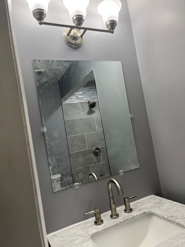 bathroom with a sink and tiled shower