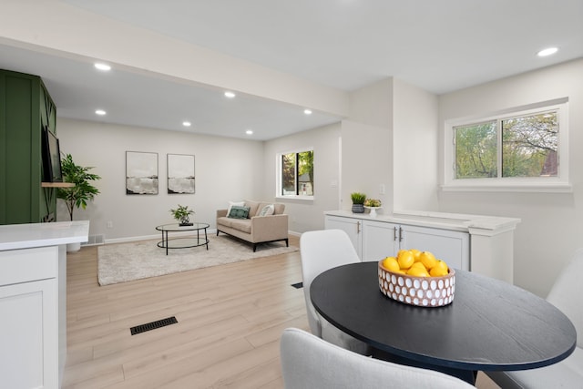 dining area featuring light wood-type flooring, recessed lighting, and baseboards
