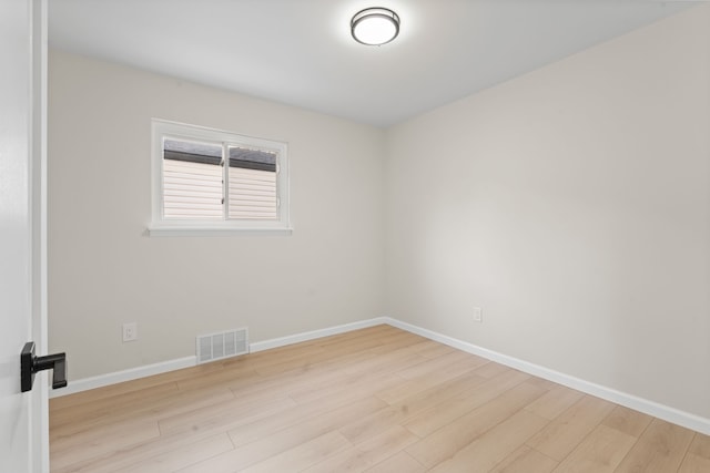 empty room featuring wood finished floors and baseboards