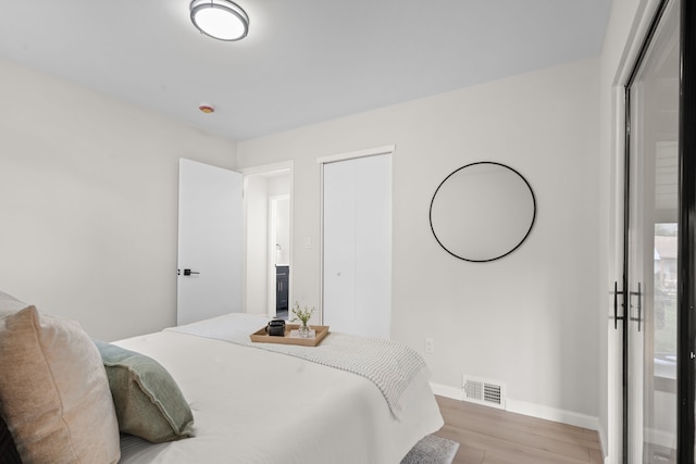 bedroom featuring wood finished floors and baseboards