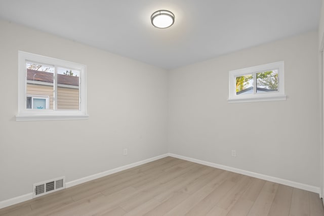 unfurnished room with light wood finished floors and baseboards