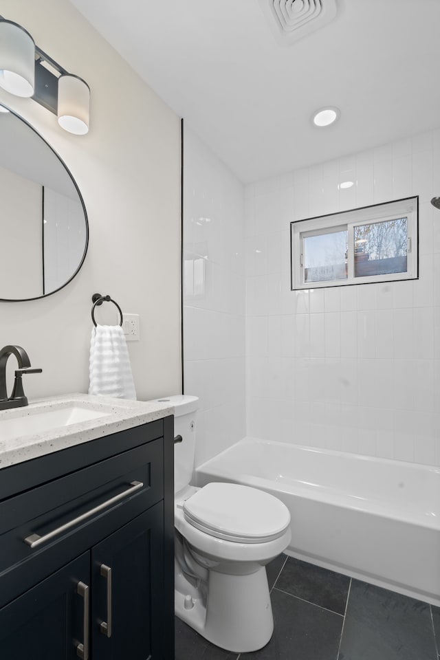 bathroom with tile patterned flooring, vanity, toilet, and bathing tub / shower combination