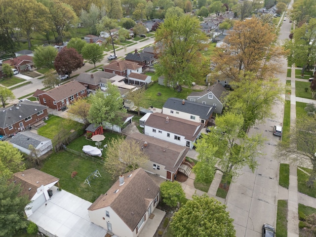 aerial view of property and surrounding area featuring nearby suburban area