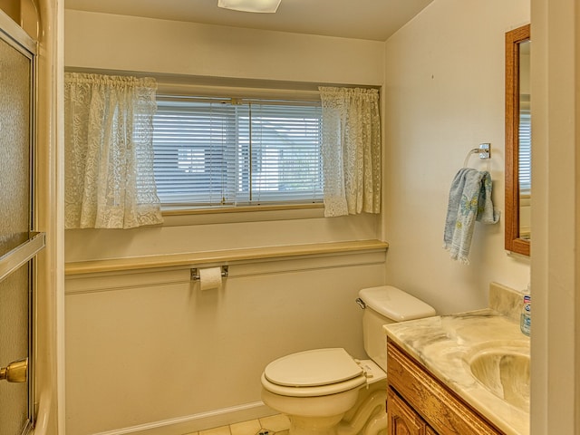 bathroom with a shower with door, toilet, tile patterned floors, and vanity