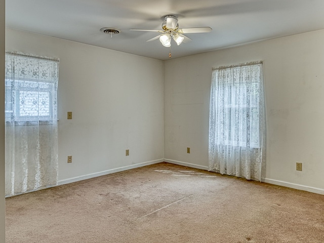 unfurnished room with carpet flooring, ceiling fan, and baseboards