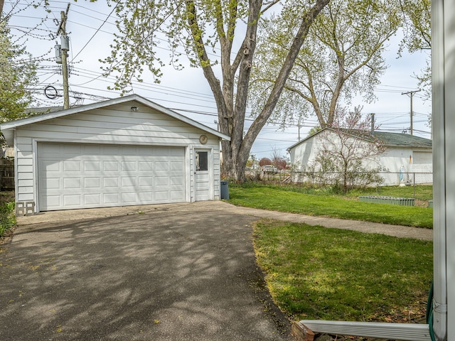 detached garage featuring fence