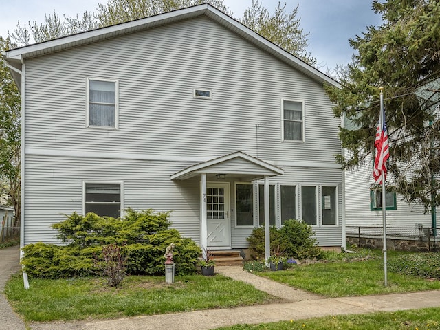 traditional-style home with fence and a front yard