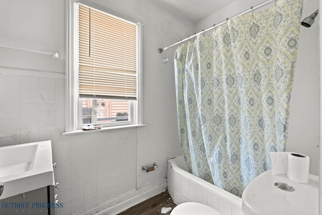bathroom with toilet, shower / bath combination with curtain, and vanity