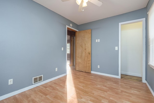 unfurnished bedroom featuring visible vents, a ceiling fan, light wood finished floors, and baseboards