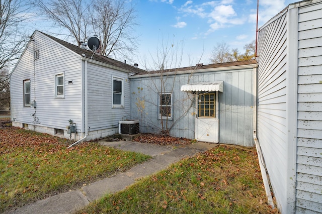 back of house featuring cooling unit