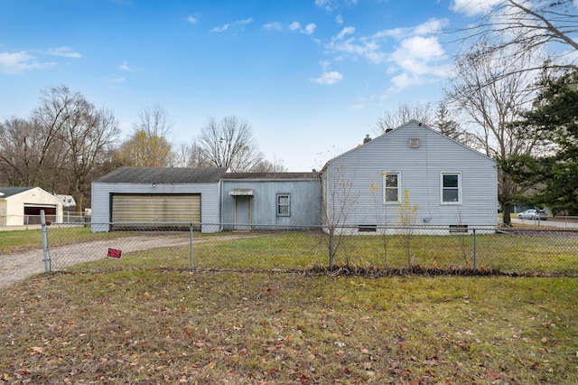 view of front of property featuring a garage, driveway, fence private yard, and a front lawn