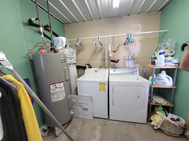 clothes washing area with laundry area, washer and clothes dryer, and electric water heater