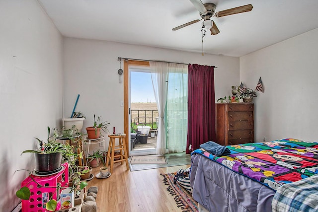 bedroom with access to outside, a ceiling fan, and wood finished floors