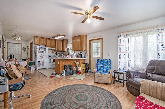 living room featuring light wood-style floors and a ceiling fan