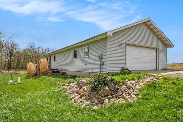 view of side of home with a detached garage