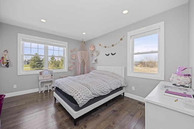 bedroom featuring recessed lighting, baseboards, multiple windows, and dark wood-type flooring