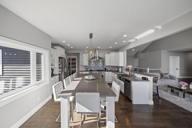 dining area with recessed lighting, baseboards, and dark wood finished floors