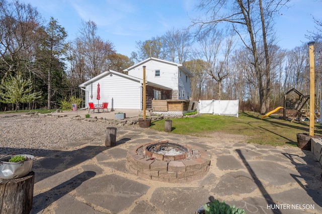 view of patio / terrace with a playground and an outdoor fire pit