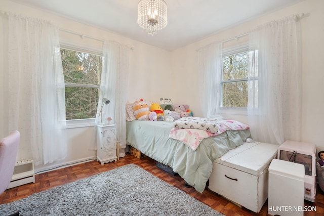 bedroom with a chandelier and multiple windows